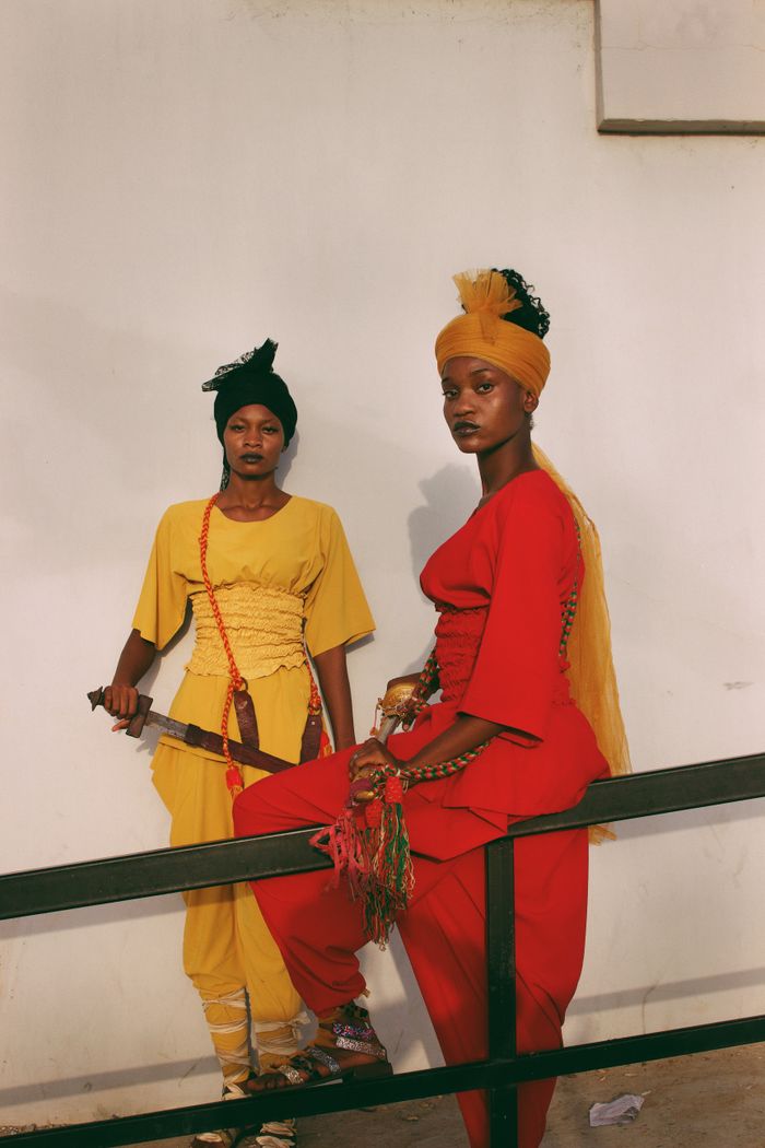 Vibrant portrait of two women in traditional attire, showcasing Nigerian culture.